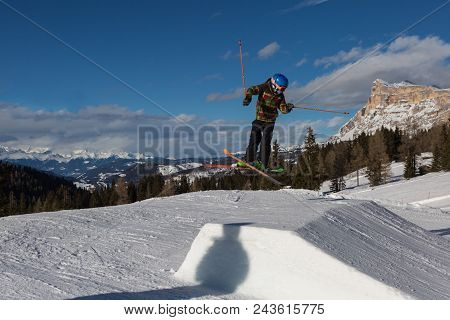 Skier In Action: Ski Jumping In The Mountain Snowpark.