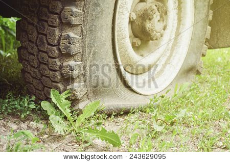 Flat Tire On The Suv Close Up. Abstract Background.