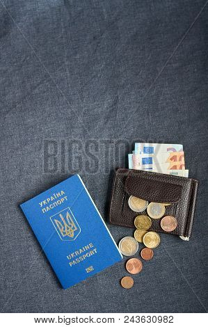 Blue Ukrainian Passport On Gray Background With Euro Monay In Purse