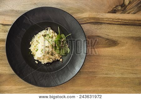 Top  View At Risotto With Gem Fit And Levisticum Celery On A Wood Table Composition