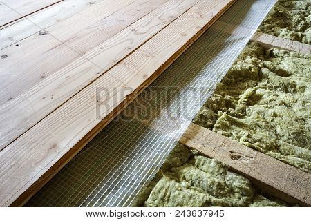 Installation Of New Floor Of Wooden Natural Planks And Mineral Wool Insulation For Isolation And Kee