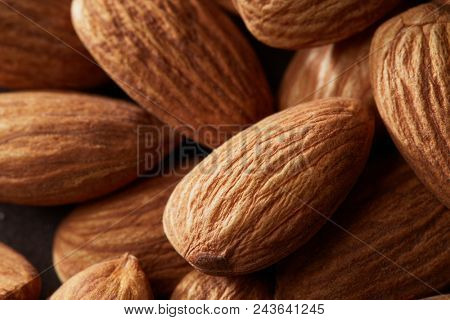 Background of big raw peeled almonds macro shot