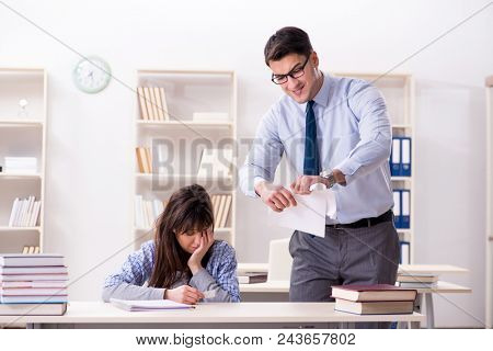 Male lecturer giving lecture to female student