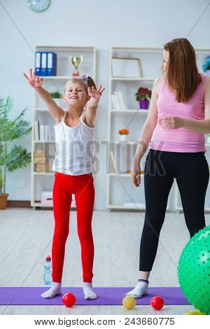 Girl and mother exercising at home