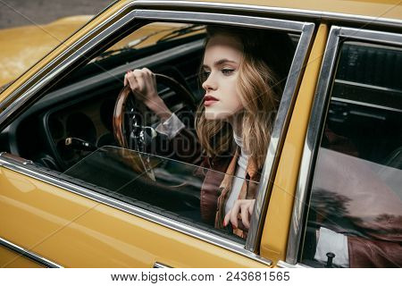 Attractive Stylish Girl Sitting In Tero Car And Looking Away