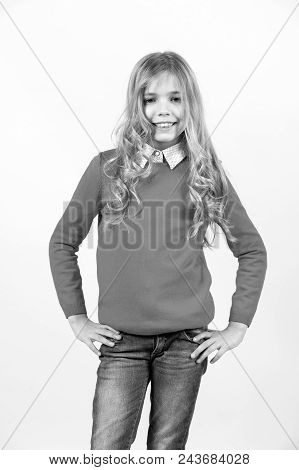 Kid Girl In Red Sweater, Blue Jeans With Long Curly Blond Hair Happy Smile On Orange Background. Fas