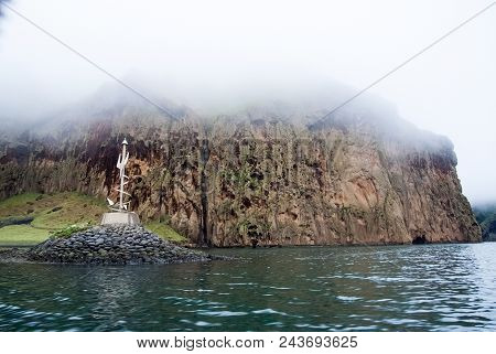 Rocky Sea Coast On Misty Sky In Heimaey, Iceland. Mountain Formation Along Coastline. Sea On Mountai