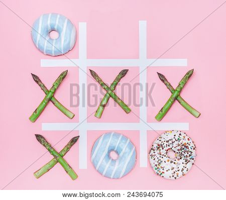 Tik Tak Toe Game With Donuts And Asparagus. Health Nutrition Concept Image