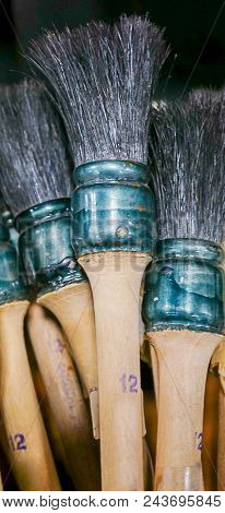 A Collection Of Large Wooden Handle Paint Brushes