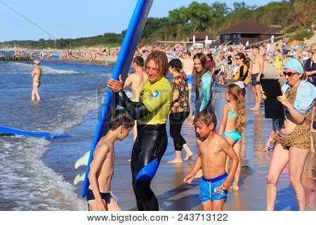 Zelenogradsk, Kaliningrad Region, Russia - July 29, 2017: Unknown Surfer With Surfboard Standing On 