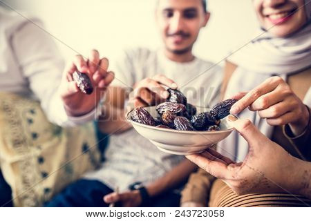 Muslim family having dried dates as a snack