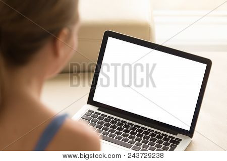Casual Woman Looking At Laptop With Mockup Blank Screen. Empty Copy Space On Monitor For  Advertisem