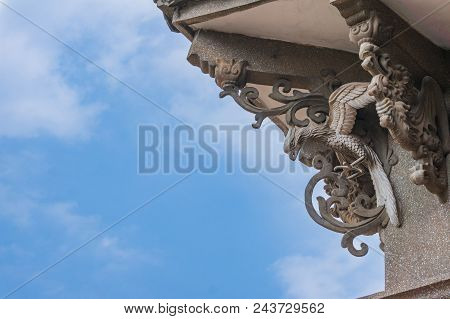 Stone Statue Of Phoenix And Dragon With Blue Sky Background At Hai Tian Tang Gou Building In Gulangy