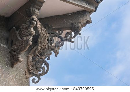 Stone Statue Of Phoenix And Dragon With Blue Sky Background At Hai Tian Tang Gou Building In Gulangy