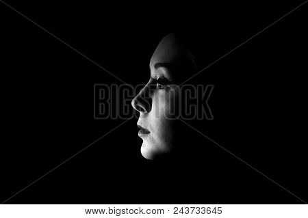 Black And White Photo Of A Beautiful Woman Face In The Darkness