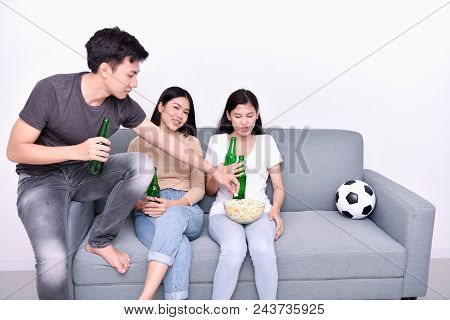 Concept Of Cheering. Asian Teenagers Watching Football On Television. People Are Cheering And Winnin