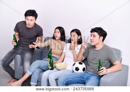 Concept Of Cheering. Asian Teenagers Watching Football On Television. People Are Cheering And Winnin