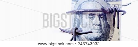 Economic Warfare, Sanctions And Embargo Busting Concept. Us Dollar Money Wrapped In Barbed Wire.