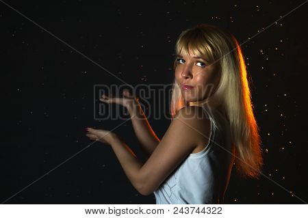 Nice Girl In The White Shirt And Water Drops Behind And Arround Her Illuminated By Light During A Ph