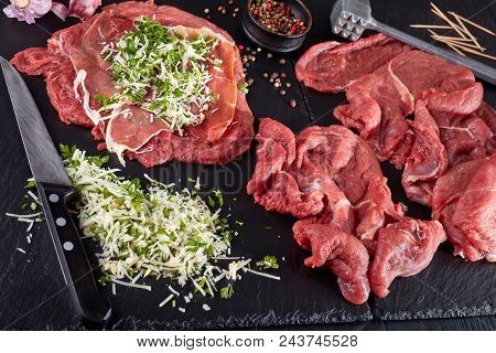 Raw Braciole - Prosciutto, Grated Parmesan Cheese And Finely Chopped Parsley Lay On Beef Steaks On A
