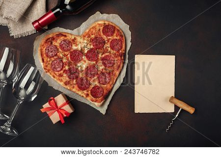 Heart Shaped Pizza With Mozzarella, Sausagered And Wine Bottle, Corkscrew, Wineglass . On Rusty Back