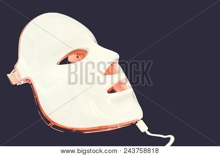 Light Rejuvenating Mask For Facial Skin Therapy On Black Background