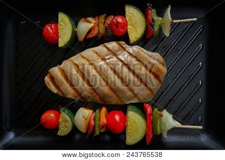 grilled chicken breast with brochette vegetable on grill pan