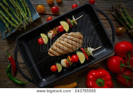 grilled chicken breast with brochette vegetable on grill pan
