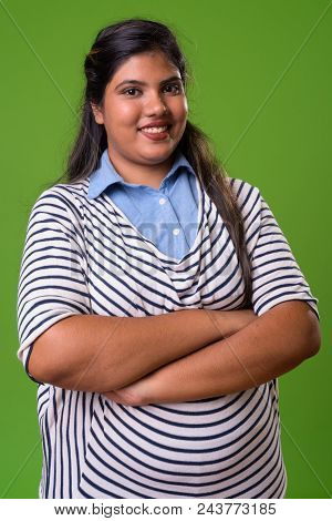 Studio Shot Of Young Overweight Beautiful Indian Businesswoman Against Chroma Key With Green Backgro