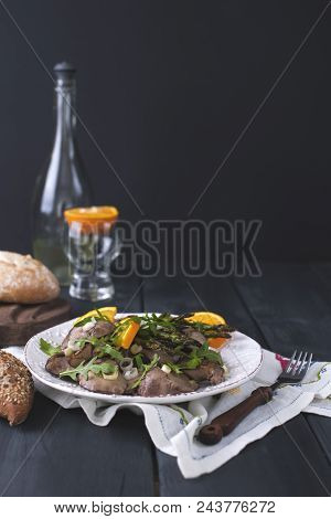 A Delicious Healthy Dinner, A Warm Chicken Liver Salad With Oranges And Rucola, On A Black Wooden Ba