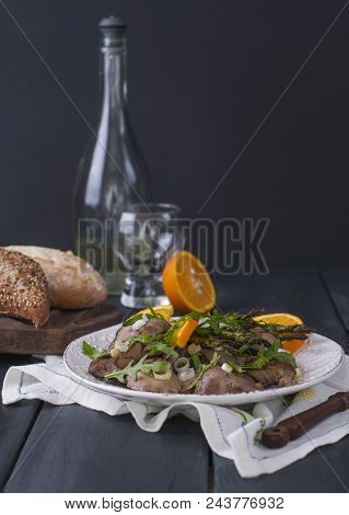 A Delicious Healthy Dinner, A Warm Chicken Liver Salad With Oranges And Rucola, On A Black Wooden Ba