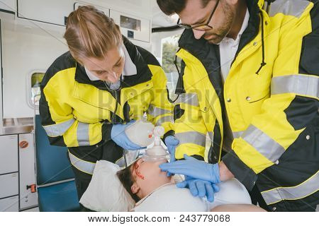 Medics putting tube in trachea of injured woman to ventilate her