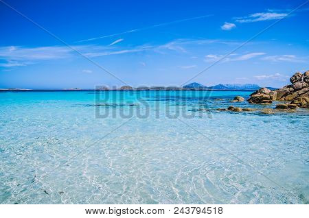 Clear Amazing Azure Coloured Sea Water With Granite Rocks In Capriccioli Beach, Sardinia, Italy.