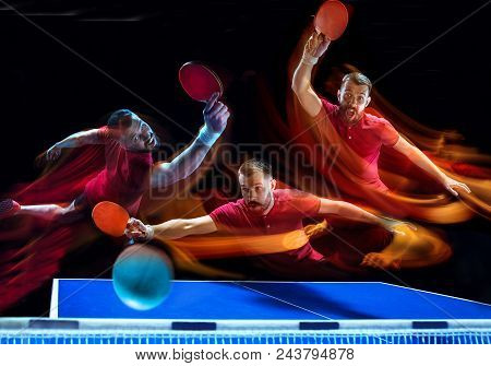 The Table Tennis Player In Motion. Fit Young Sports Man Tennis-player In Play On Black Background Wi
