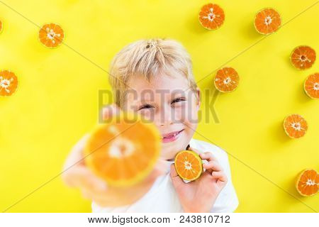 Toothless Boy Child White T-shirt Smiling Posing Have Fun With Tropical Summer Fruit Tangerine Yello