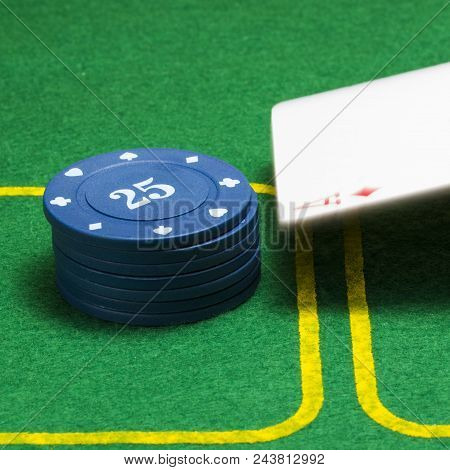 Column Of Blue Poker Chips And A Falling Ace Of Diamonds On A Green Canvas Concept Of Casino And Gam