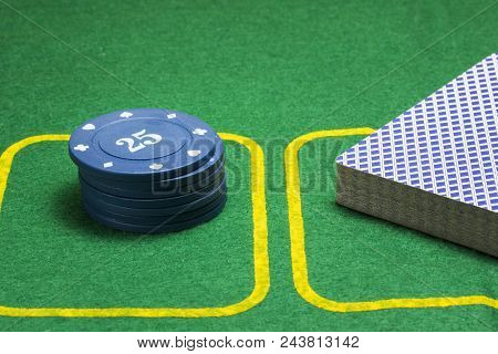 Column Of Blue Poker Chips And A Deck Of Cards On A Green Canvas Concept Of Gambling And Casino