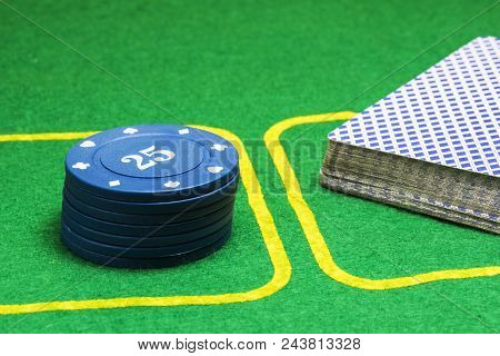 Poker Chips And A Deck Of Cards On A Green Canvas The Concept Of Casino And Gambling
