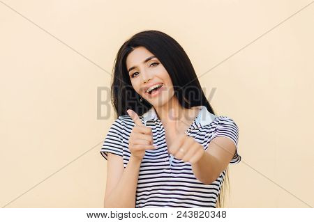 Shot Of Attractive European Female Gives Double Thumb Up, Has Positive Expression, Has White Teeth W