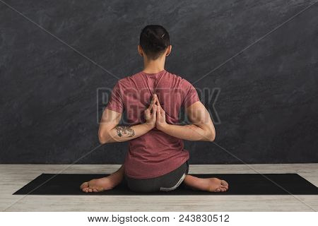 Young Man Practicing Yoga, Making Asana Exercises. Guy Do Reverse Prayer Pose, Back And Shoulders St