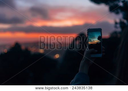 Young Woman Taking Photo With Her Phone