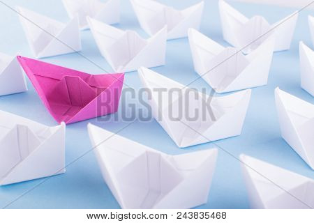 One Unique Pink Paper Boat Among Many Ones. Different Paper Ships As Think Different And Creativity 