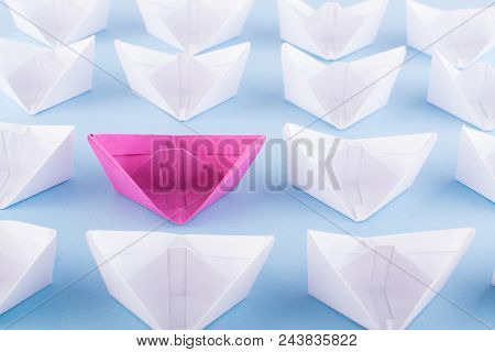 One Unique Pink Paper Boat Among Many Ones. Different Paper Ships As Think Different And Creativity 