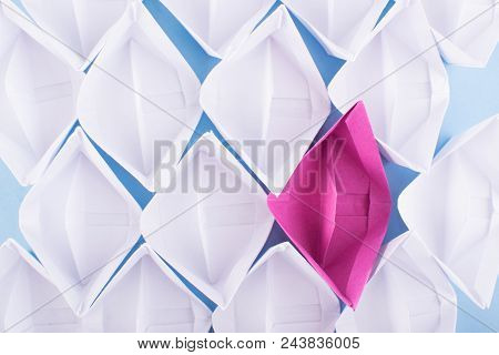 One Unique Pink Paper Boat Among Many Ones. Different Paper Ships As Think Different And Creativity 