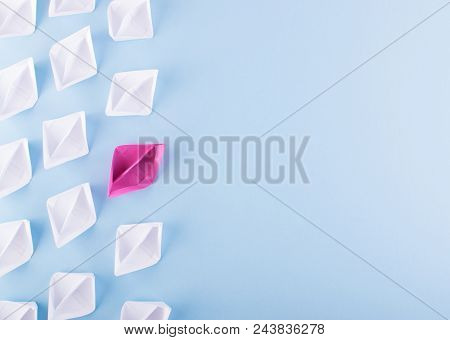 One Unique Pink Paper Boat Among Many Ones. Different Paper Ships As Think Different And Creativity 