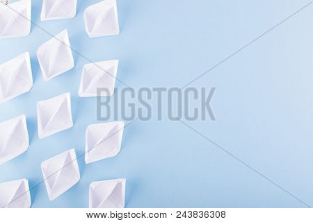 White Paper Boats Or Paper Ships Origami On Blue Background Top View With Place For Text