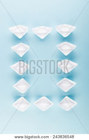 White Paper Boats Or Paper Ships Origami On Blue Background Top View With Place For Text
