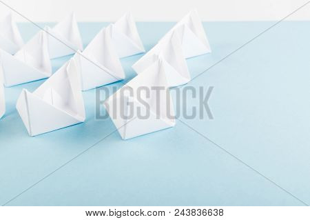 White Paper Boats Or Paper Ships Origami On Blue Background