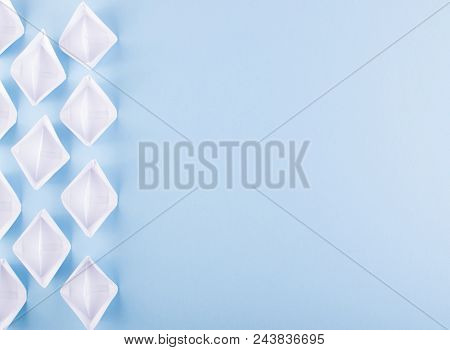 White Paper Boats Or Paper Ships Origami On Blue Background Top View With Place For Text