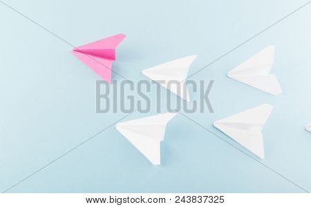 One Unique Pink Paper Plane Among Many Ones. Different Paper Airplanes As Individuality And Leadersh